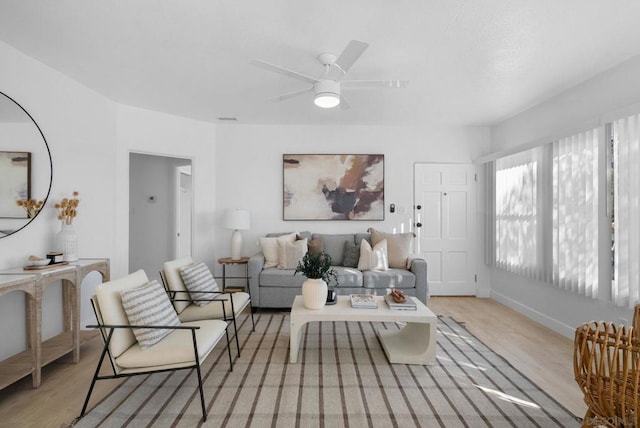 living room featuring ceiling fan and light wood-type flooring