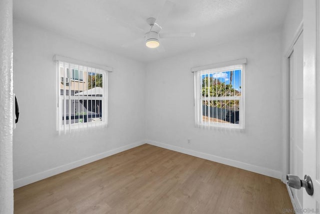 spare room with ceiling fan and light hardwood / wood-style flooring