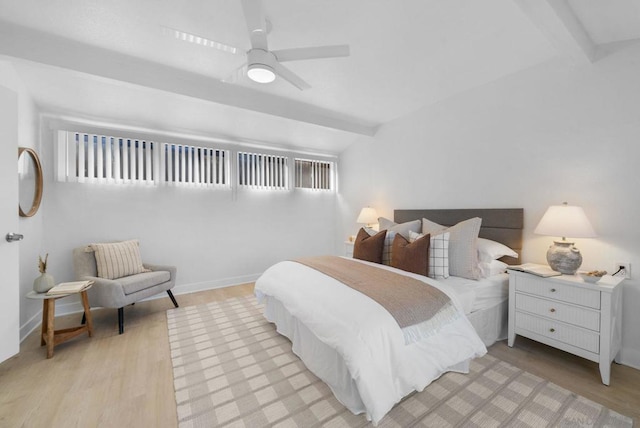 bedroom featuring ceiling fan, beam ceiling, and light hardwood / wood-style flooring