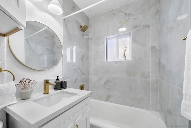 bathroom featuring vanity and tiled shower / bath combo