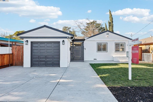 ranch-style house with a garage, an outdoor structure, and a front lawn