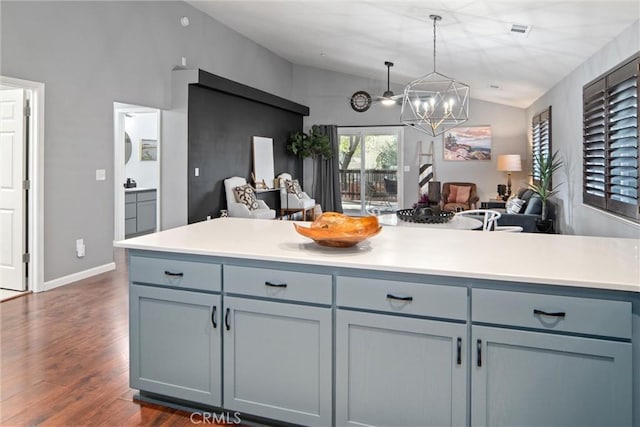 kitchen featuring lofted ceiling, hanging light fixtures, and dark hardwood / wood-style flooring