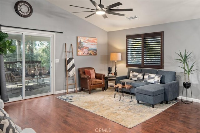 living room featuring vaulted ceiling, dark wood-type flooring, and ceiling fan