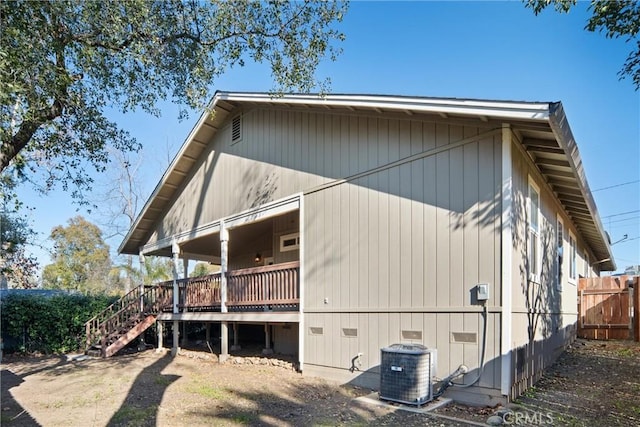 view of side of property featuring central AC and a deck