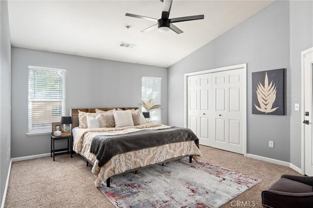 bedroom featuring lofted ceiling, light colored carpet, a closet, and ceiling fan