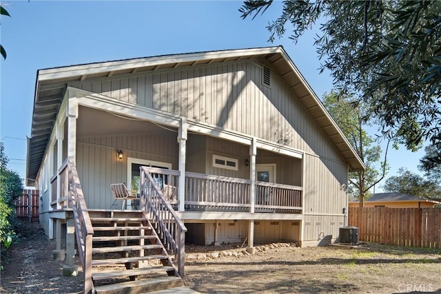 rear view of property with central air condition unit and a porch