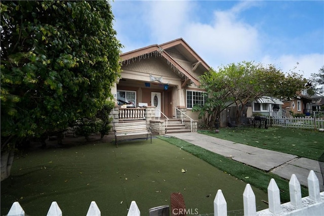 view of front of home featuring fence