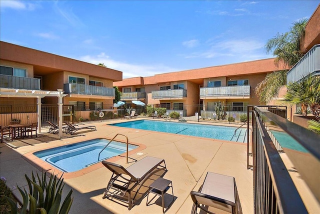 view of pool with a hot tub and a patio area