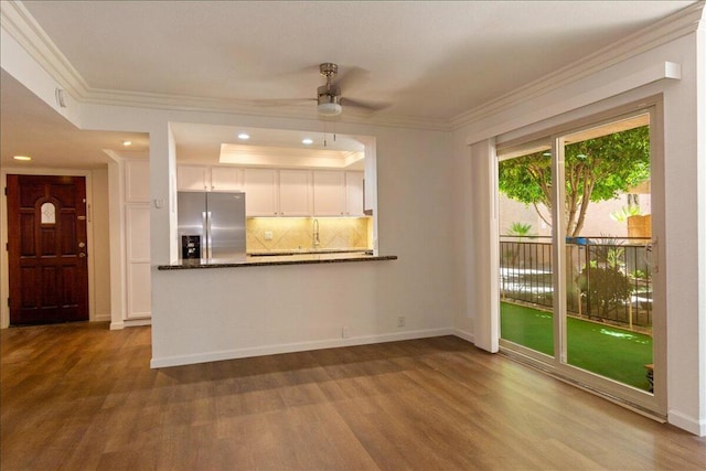 unfurnished living room featuring crown molding, ceiling fan, and hardwood / wood-style floors