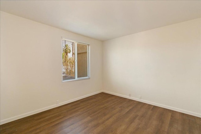 spare room with dark hardwood / wood-style floors