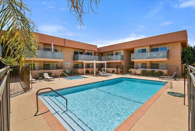 view of pool featuring a hot tub and a patio area