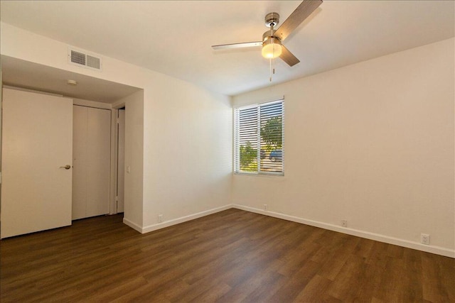 empty room featuring dark hardwood / wood-style floors and ceiling fan