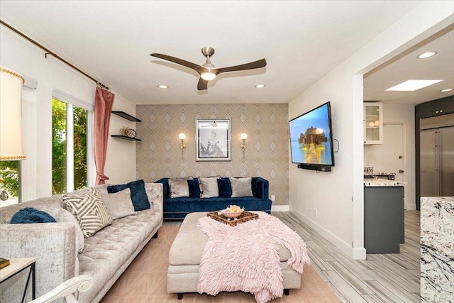 living room with light hardwood / wood-style floors and ceiling fan