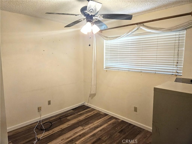 spare room with ceiling fan, dark hardwood / wood-style flooring, and a textured ceiling