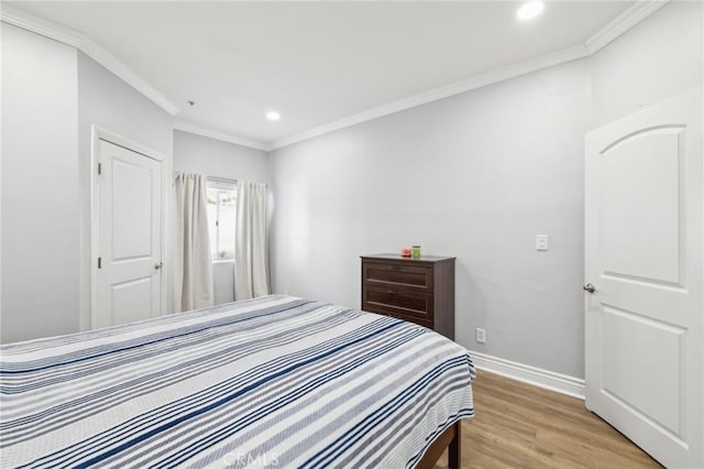 bedroom featuring ornamental molding and light wood-type flooring