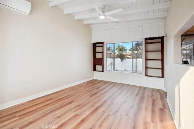 unfurnished room with beam ceiling, an AC wall unit, ceiling fan, and light wood-type flooring