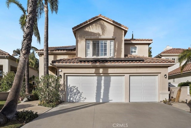 mediterranean / spanish-style house with a garage