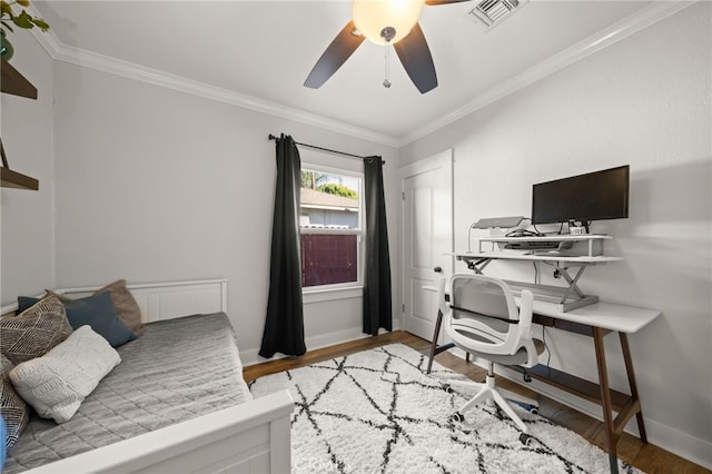 bedroom featuring crown molding, ceiling fan, and hardwood / wood-style floors