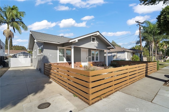 view of front of house with a garage and an outdoor structure