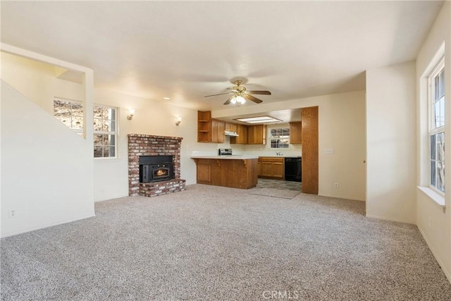 unfurnished living room with light carpet, sink, and ceiling fan