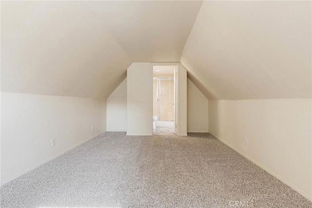 bonus room featuring lofted ceiling and carpet flooring