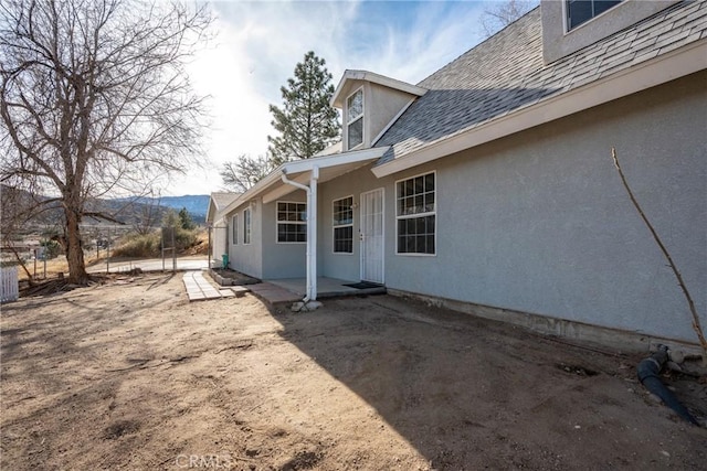 view of property exterior with a patio area