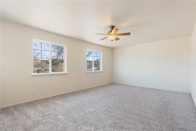 empty room featuring carpet flooring and ceiling fan