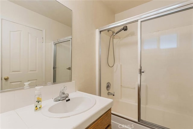 bathroom with vanity and enclosed tub / shower combo