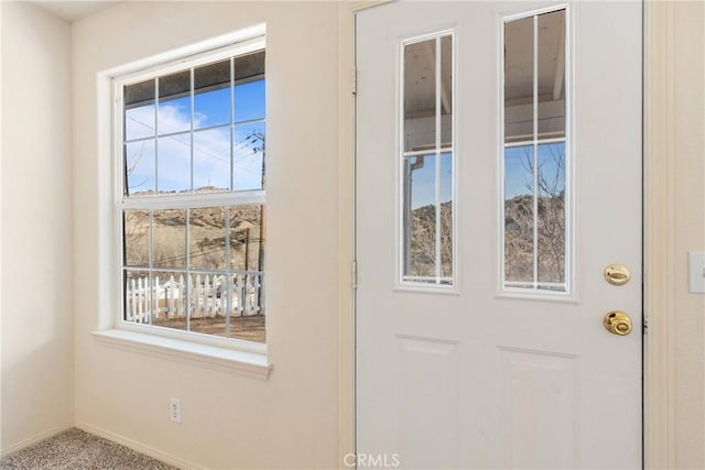 doorway to outside featuring carpet floors