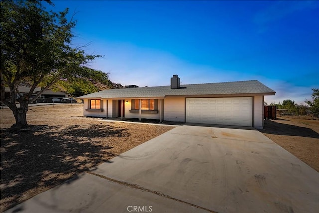 ranch-style home featuring a garage