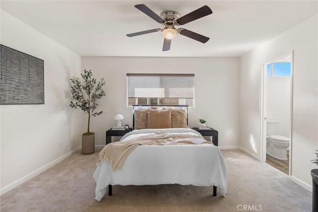 bedroom featuring light carpet, connected bathroom, and ceiling fan