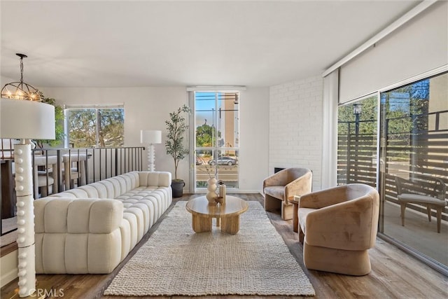 living room with an inviting chandelier and wood-type flooring