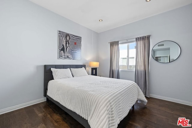 bedroom with dark wood-type flooring