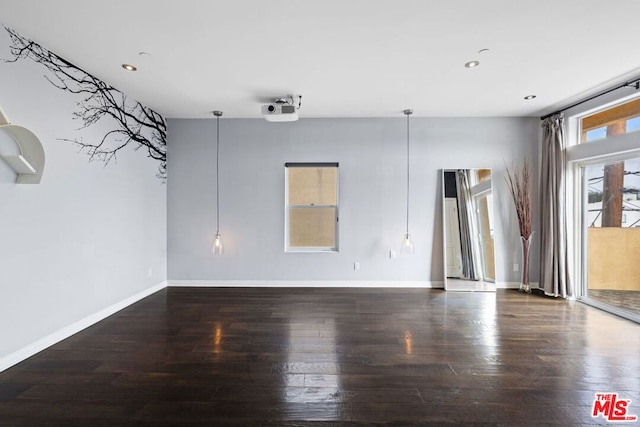 spare room with dark wood-type flooring