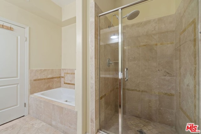 bathroom with separate shower and tub