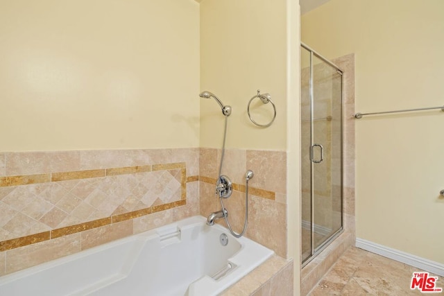 bathroom featuring shower with separate bathtub