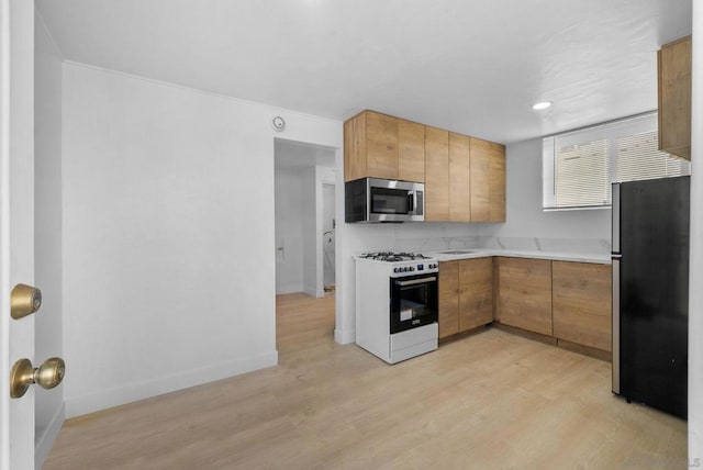 kitchen with stainless steel appliances and light hardwood / wood-style floors