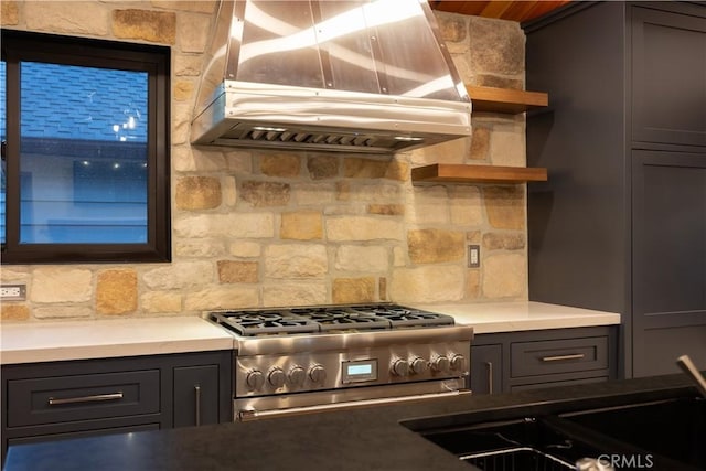 kitchen featuring ventilation hood, gas stove, tasteful backsplash, and sink