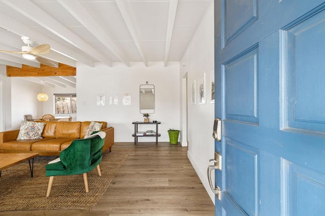 interior space featuring hardwood / wood-style floors, beamed ceiling, and ceiling fan