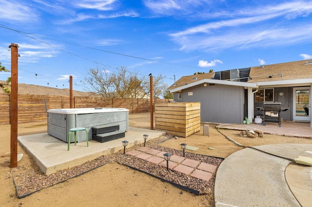 view of patio / terrace with a hot tub and area for grilling