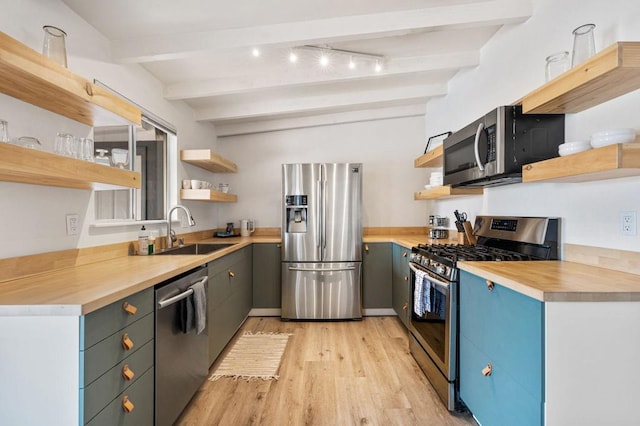 kitchen featuring stainless steel appliances, sink, wooden counters, and beam ceiling