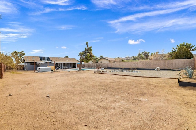 view of yard with a pool with hot tub