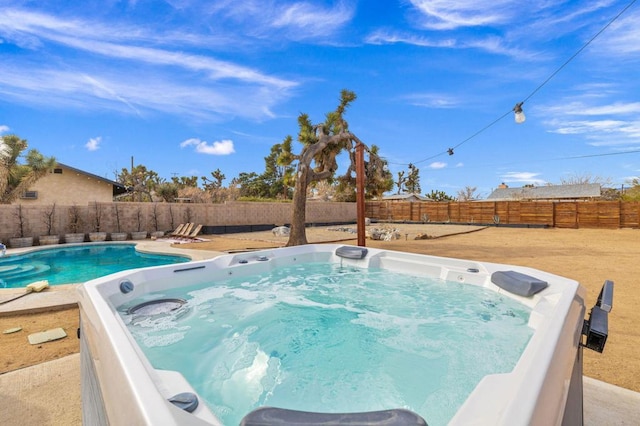 view of pool with a hot tub