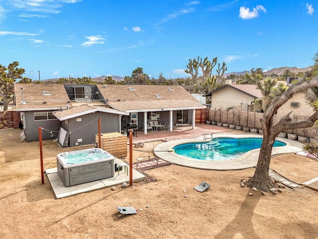 view of pool with central AC, a hot tub, and a patio