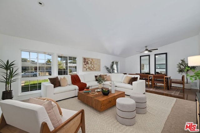 living room featuring vaulted ceiling and light hardwood / wood-style floors