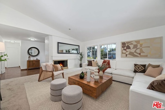 living room featuring lofted ceiling and wood-type flooring