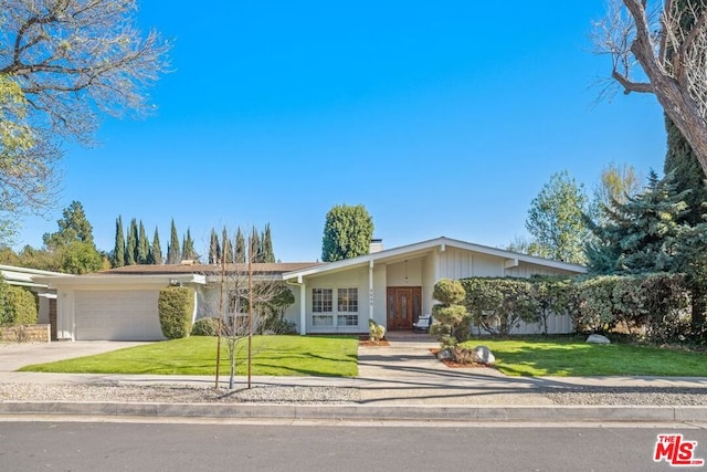 ranch-style house featuring a garage and a front lawn