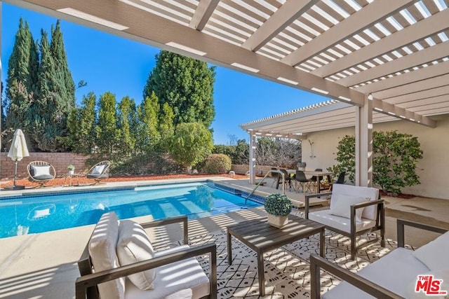 view of swimming pool with a patio area and a pergola