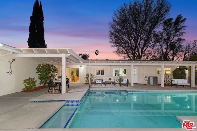 pool at dusk featuring a patio, central AC, and a pergola