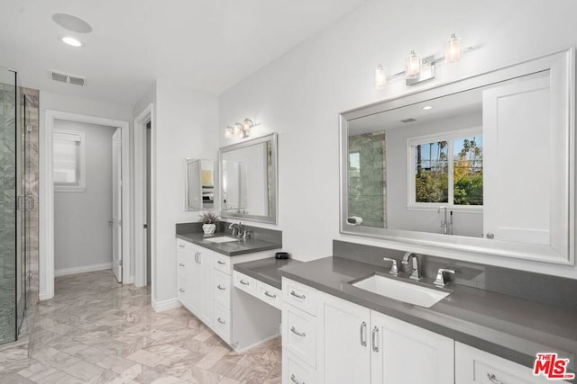 bathroom featuring vanity and a shower with shower door